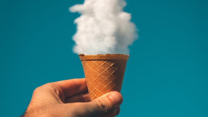 man-holding-ice-cream-cone-under-cloud-1262302 (1)