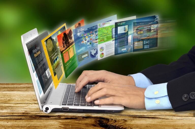 Businessman,Hand,Browsing,Internet,Websites,On,His,Laptop